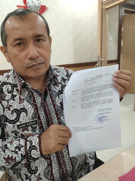 BERHENTI. Asda I Setda Indramayu, Drs Jajang Sudrajat MSi, menunjukan SK Bupati terkait pemberhantian sementara Kuwu Desa/Kecamatan Sukagumiwang Kabupaten Indramayu, Wasma